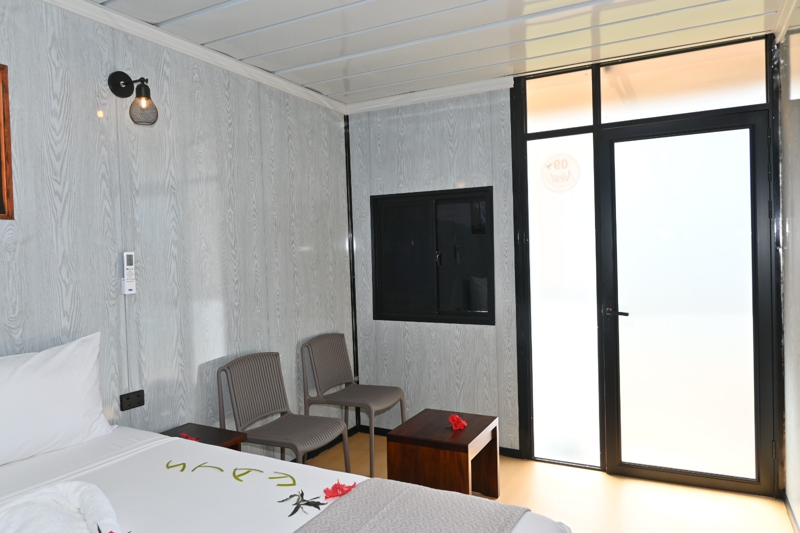 Superior Queen Nest interior with a queen bed and patio door